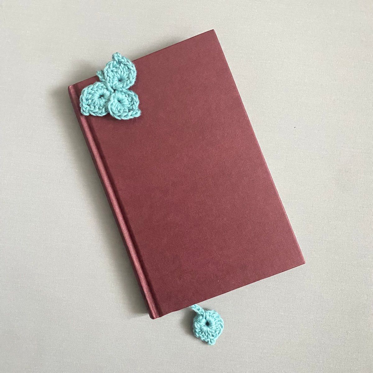 a turquoise clover leaf crochet bookmark