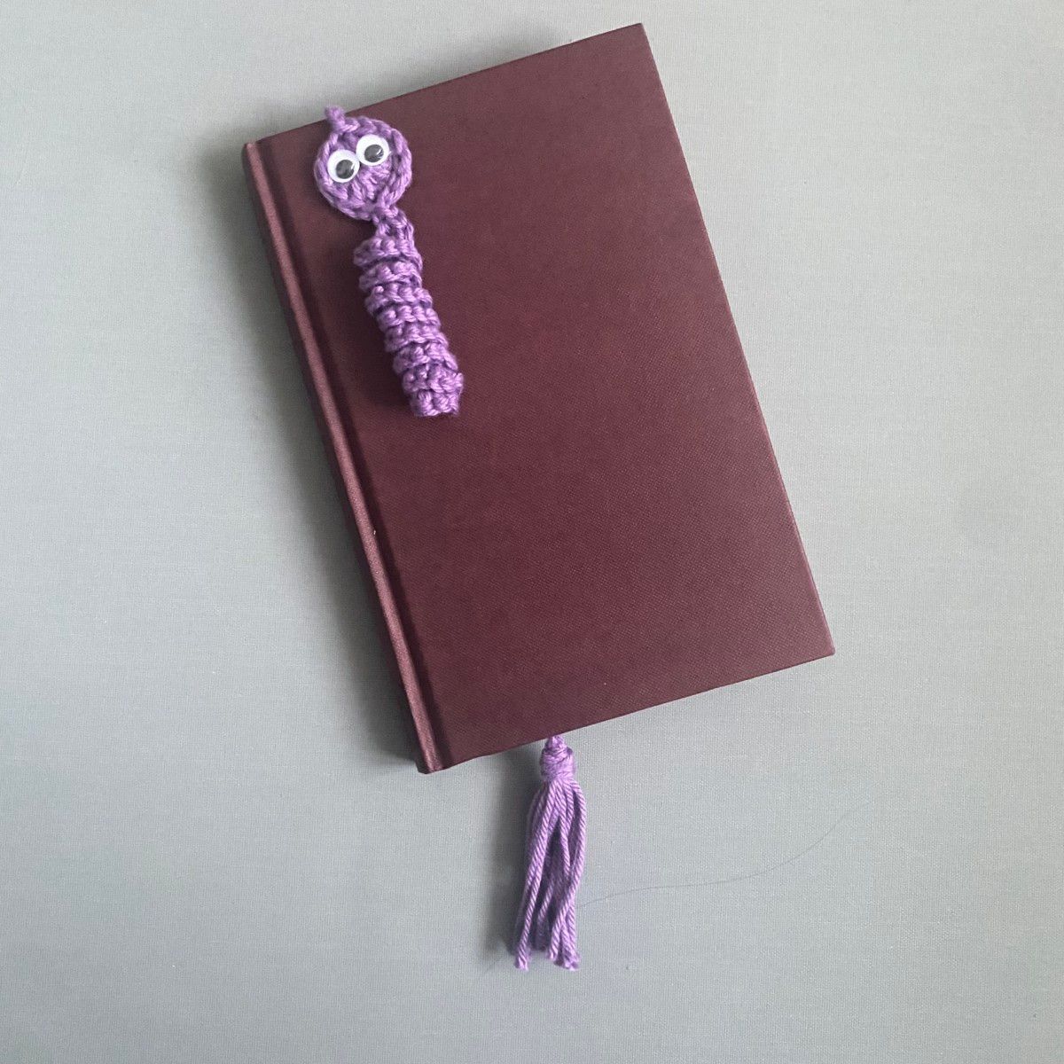 Purple bookworm (worry worm) bookmark with googly eyes